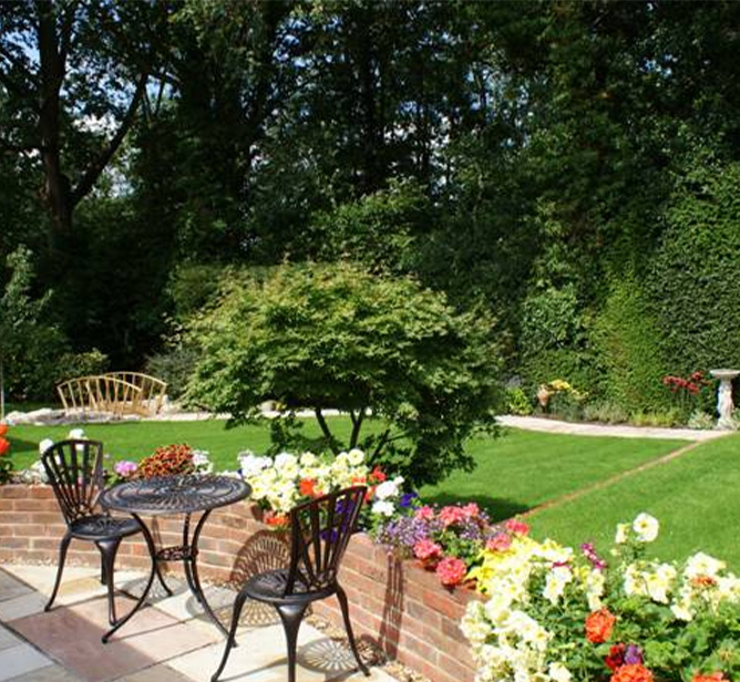 man installing landscaping border in garden with fresh soil and green herbs using gloves and gravel path for garden design 2 garden ideas 2 landscaping tips